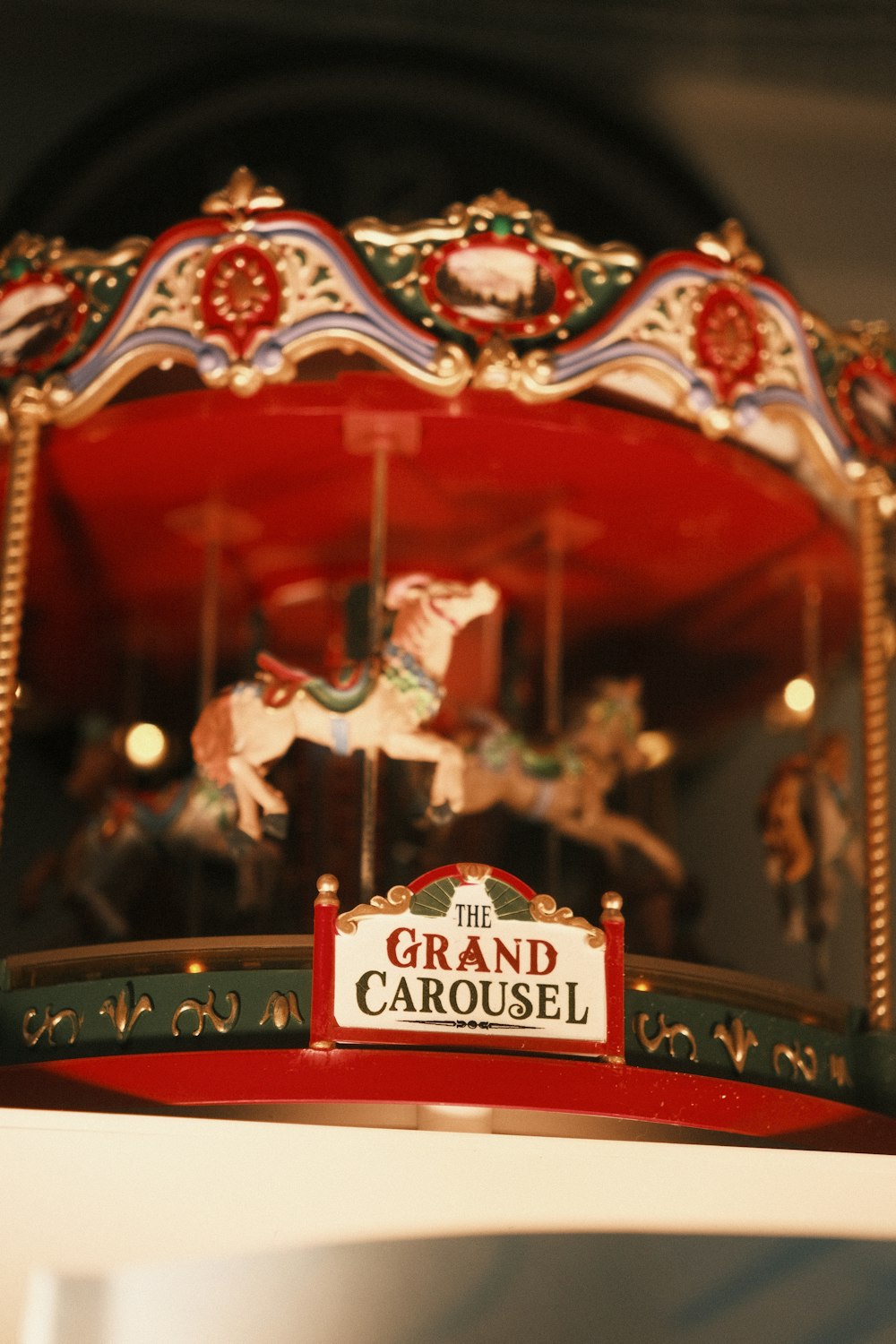a merry go round with a sign that says the grand carousel