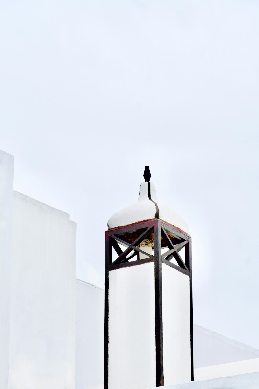 a white building with a clock on the top of it