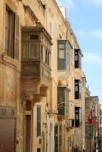 Historic Maltese architecture with vibrant streets and a sunny Mediterranean backdrop.
