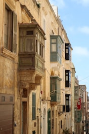 A vibrant street in Valletta filled with small Maltese shops and colorful storefronts.