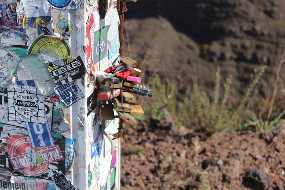 a bunch of stickers are attached to a pole