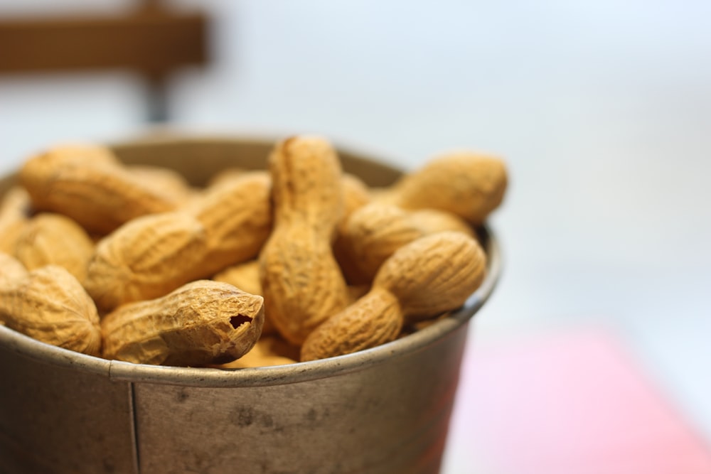 a bucket full of peanuts sitting on a table