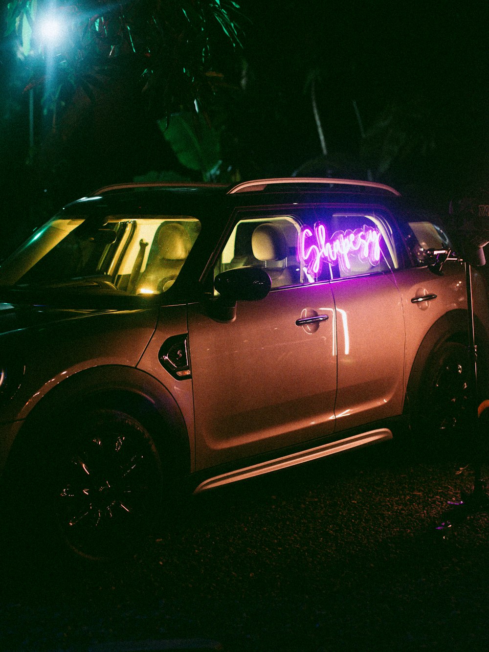 a car with a neon sign on the side of it