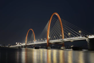 a large bridge over a body of water at night