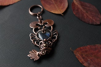 A cozy scene with a handmade crochet keychain shaped like a little owl resting on a wooden table.