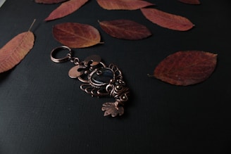 Close-up of a delicate minimalist keychain resting on a natural wood surface.