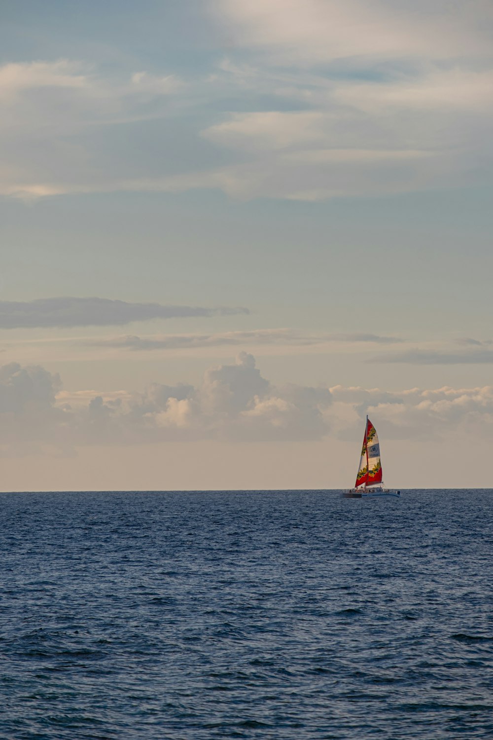 a sailboat in the middle of the ocean