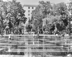 Children joyfully playing and splashing in a natural spring surrounded by trees