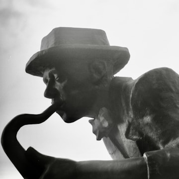 A vertical image of a saxophonist performing.