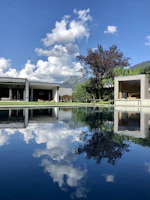 Exterior shot of a house featuring large panoramic windows under blue skies.
