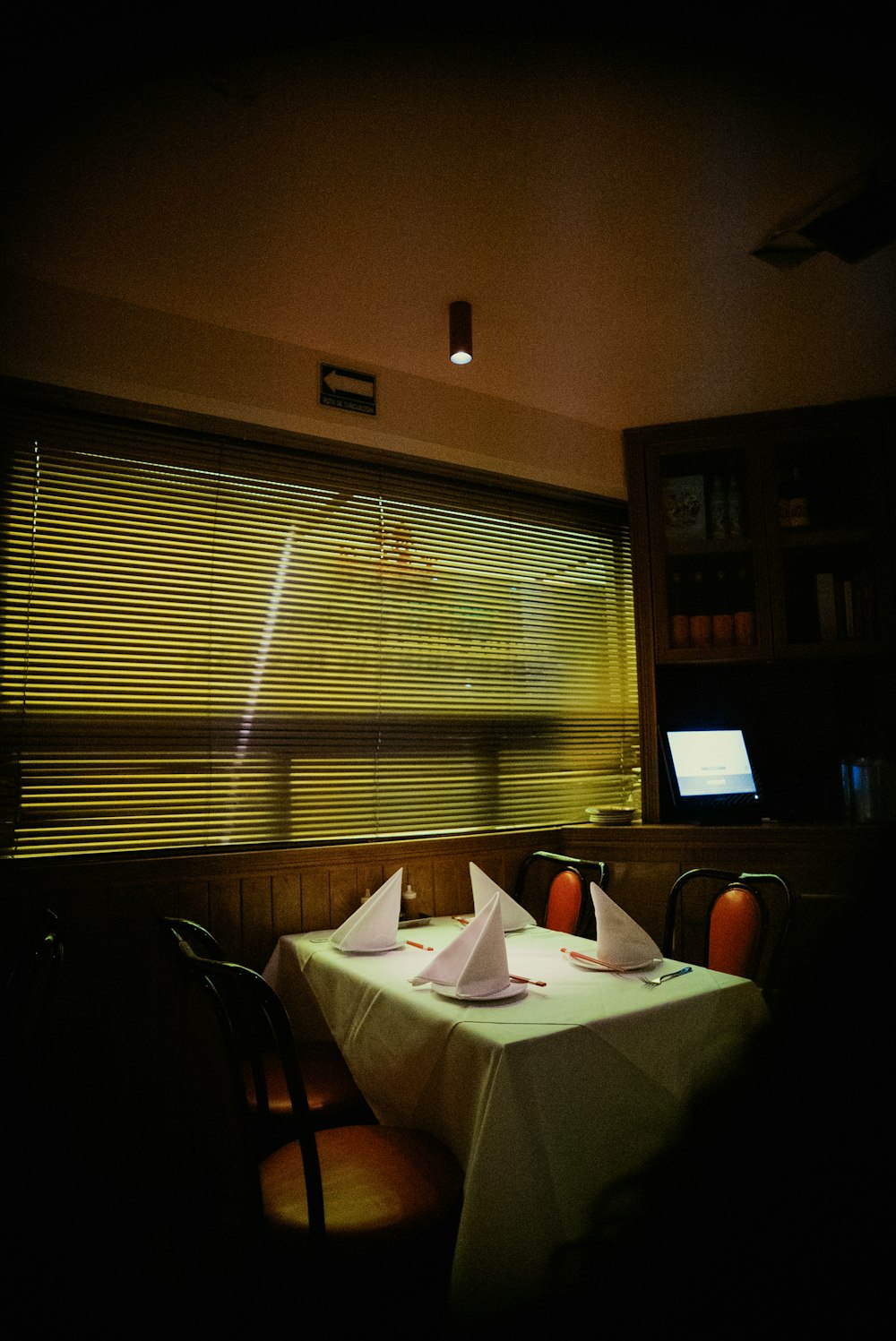 a table with two napkins on it in front of a window