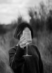 a woman holding a wine glass in her hand
