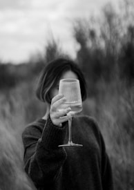 a woman holding a wine glass in her hand