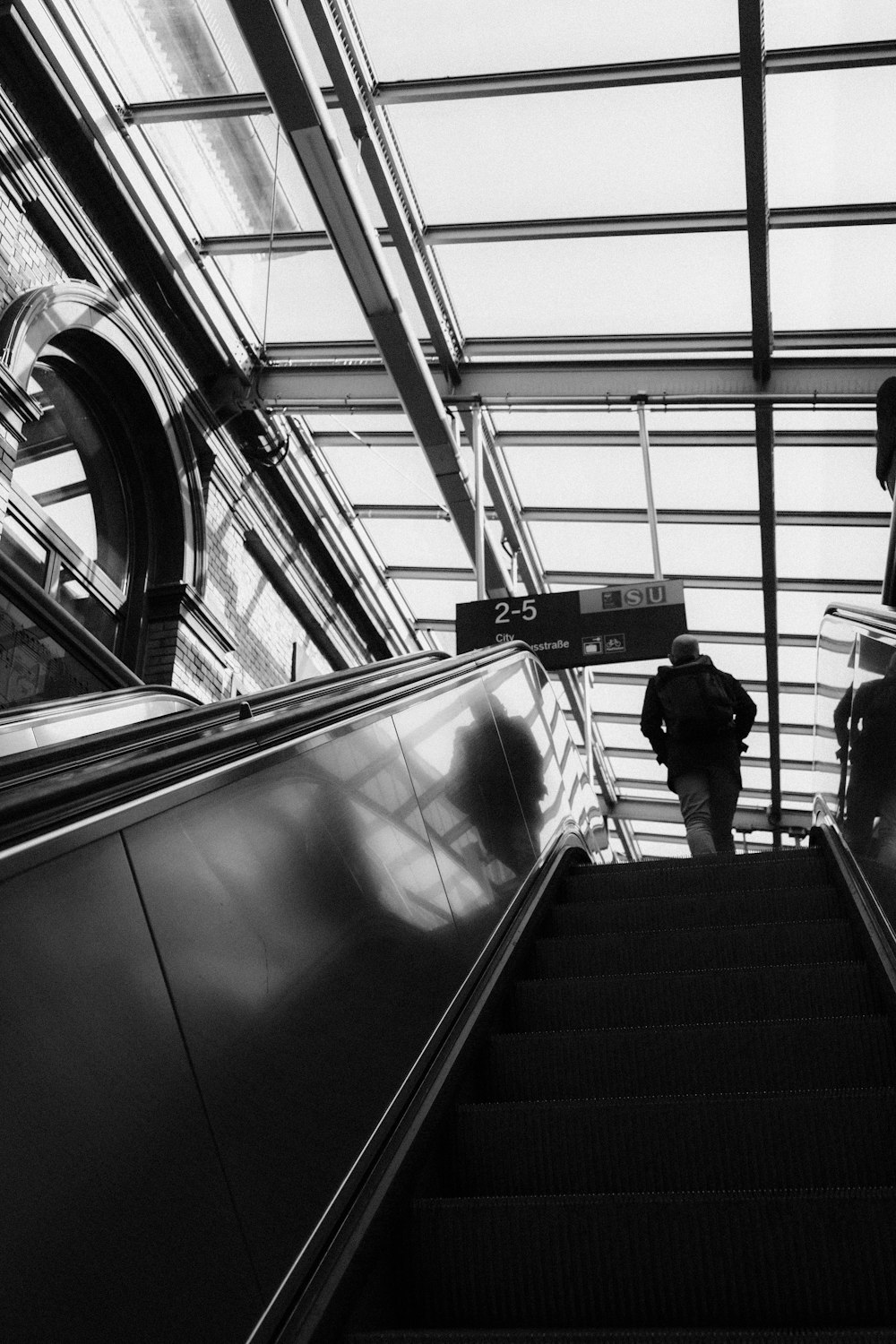 a man riding an escalator down a set of stairs