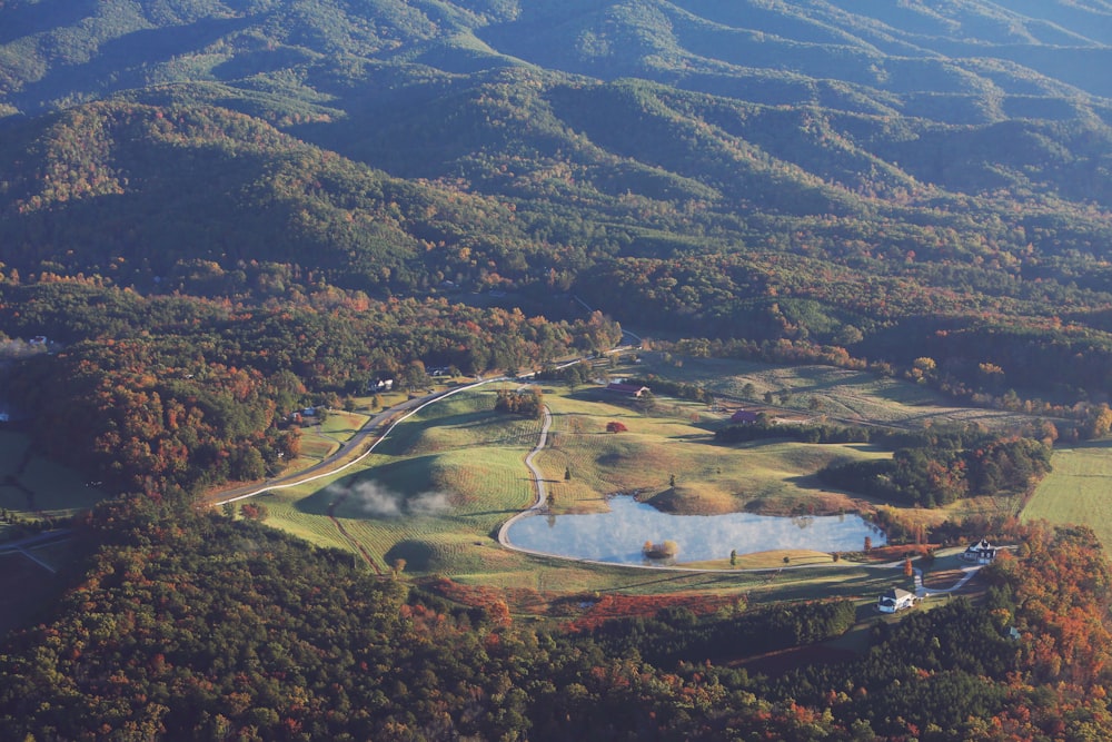 an aerial view of a golf course surrounded by mountains