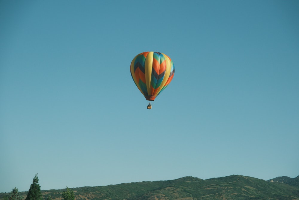 a colorful hot air balloon flying in the sky