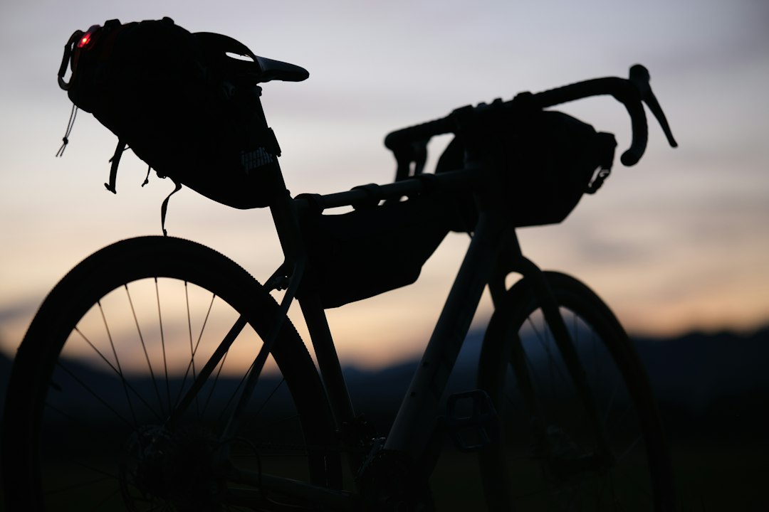 a silhouette of a bike with a bag on the back of it, Bikepacking photos from commute from work. Kranj - Slovenija