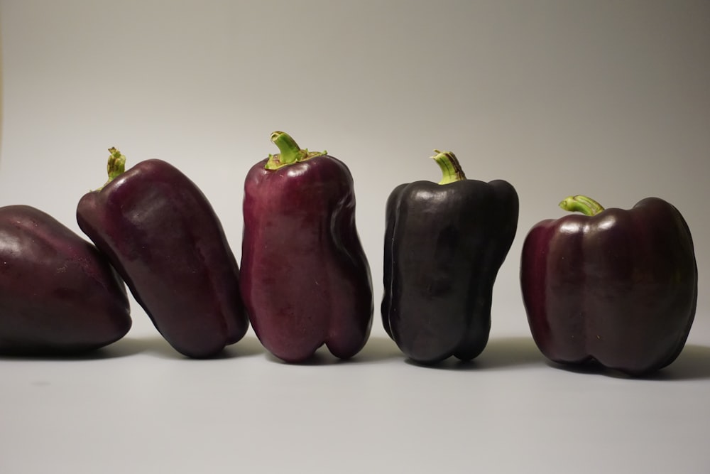 a group of red peppers sitting next to each other