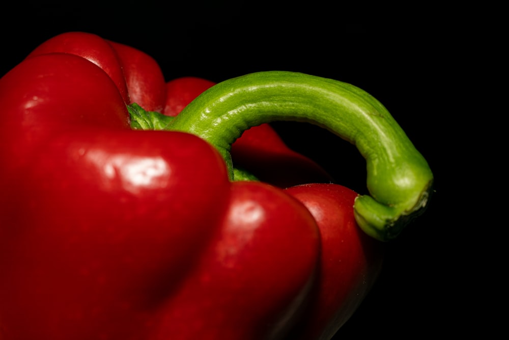 a close up of a red pepper with a green pepper