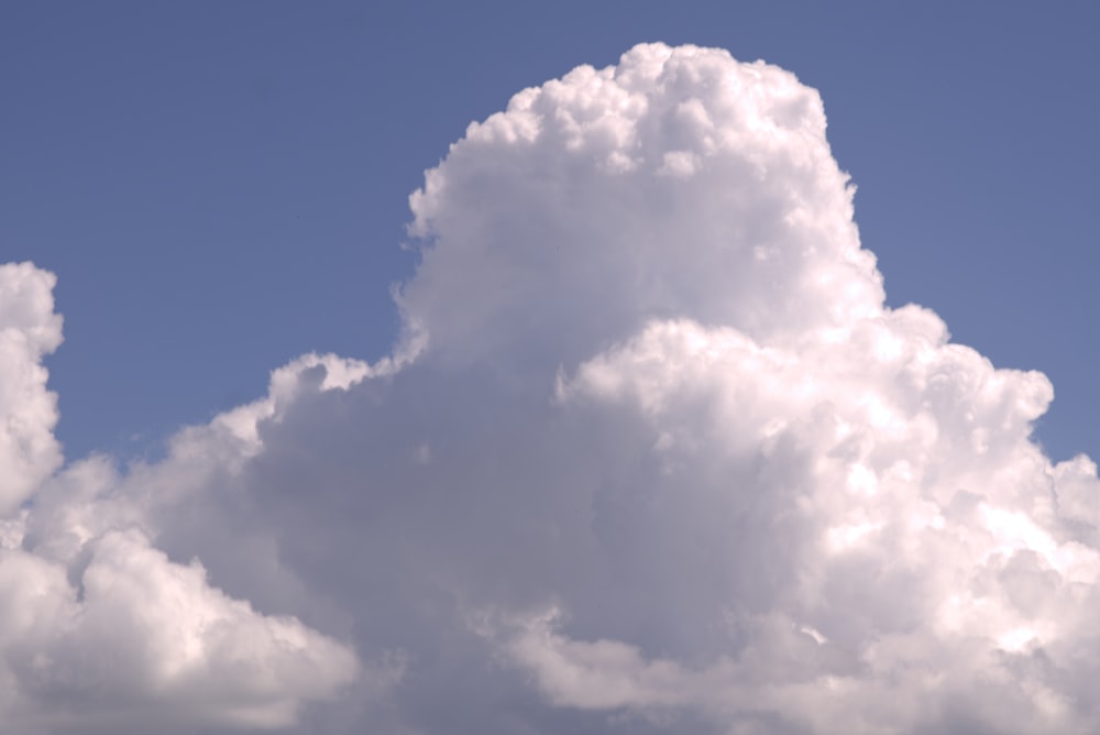 a large white cloud in a blue sky