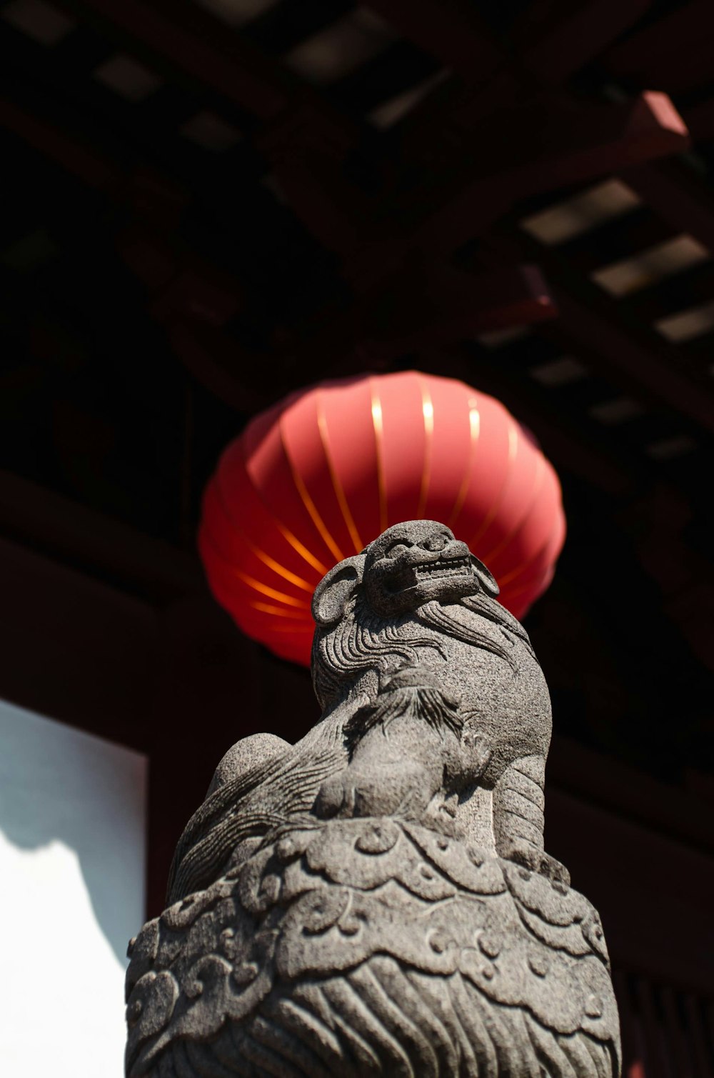 a statue with a red frisbee in the background