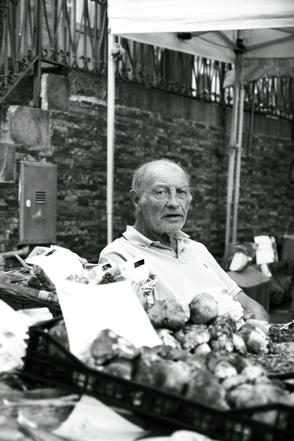 a man sitting at a table with a bunch of vegetables