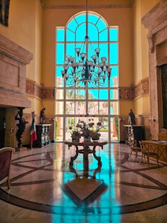 A warm, inviting reception desk inside Maryam Convention Hall with soft lighting and floral arrangements.