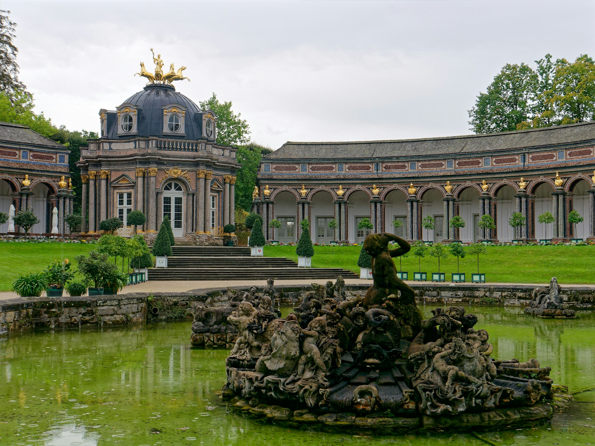 a large building with a fountain in the middle of it