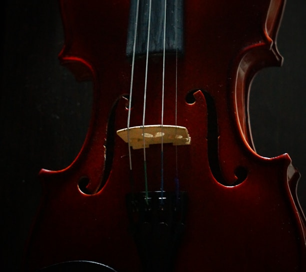 a red violin sitting on top of a table