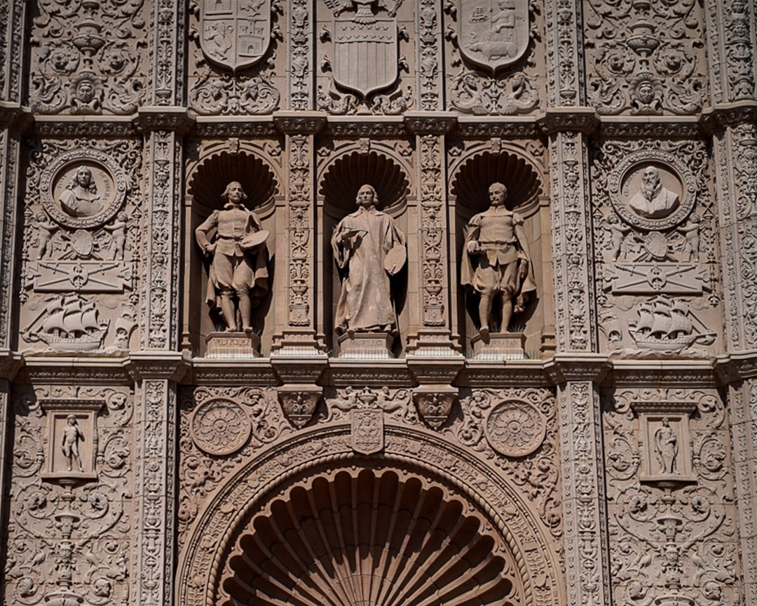 a large building with statues on the side of it,