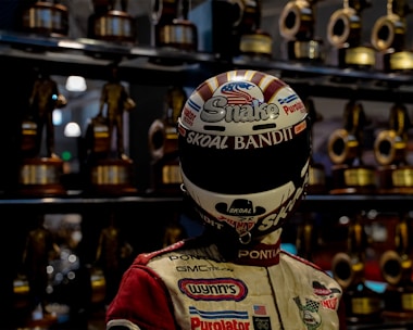 Group of kart drivers celebrating a race finish with trophies.