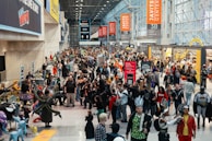 A vibrant convention scene with fans dressed as superheroes and sci-fi characters.