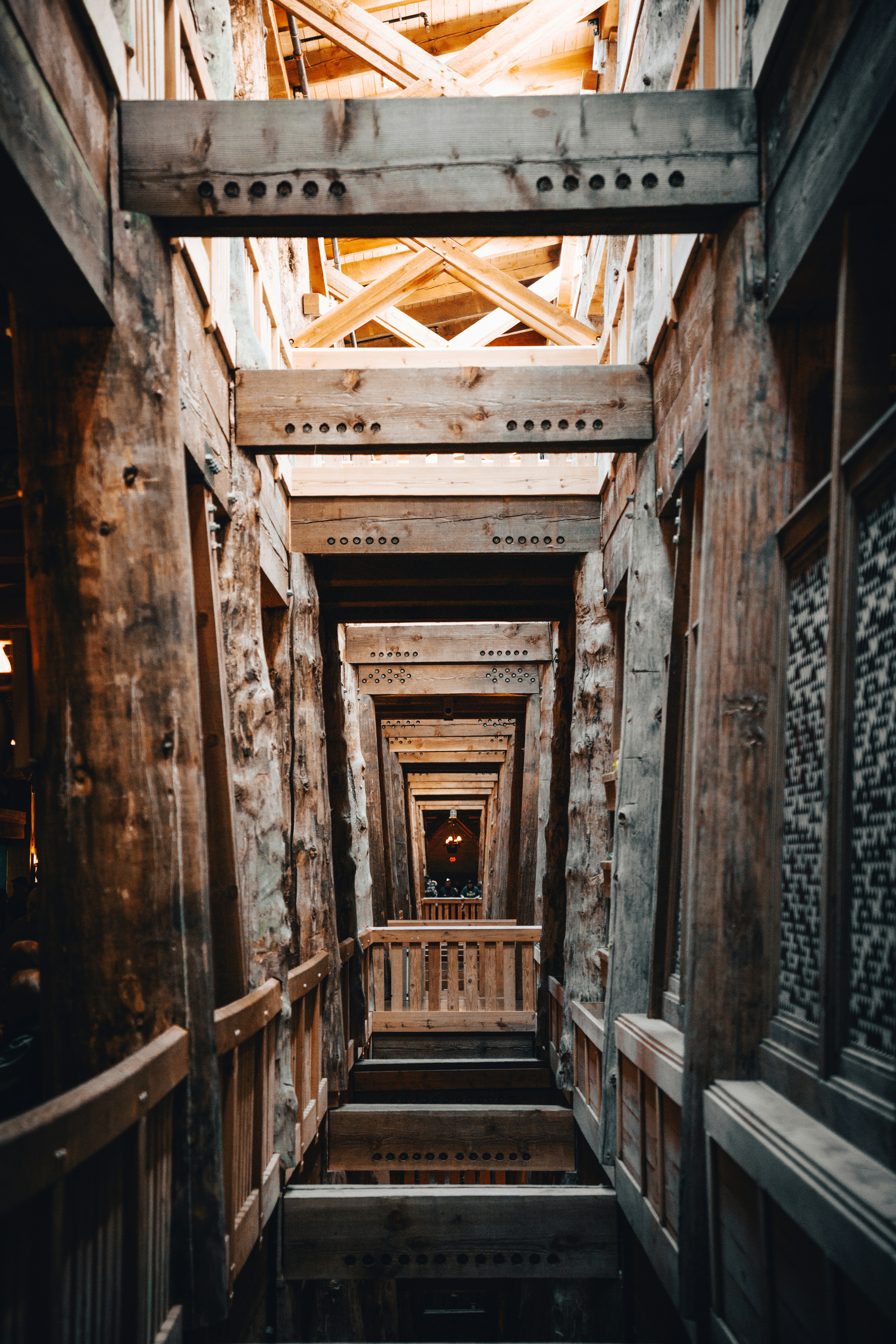 a narrow hallway with wooden walls and beams