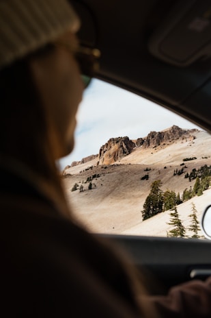 Happy traveler looking at a scenic mountain view.