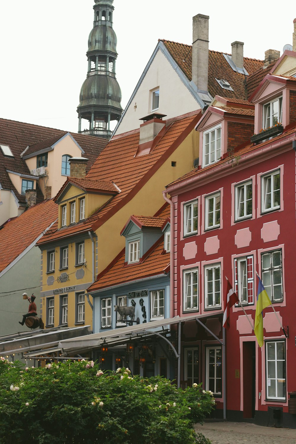 a row of buildings with a clock tower in the background