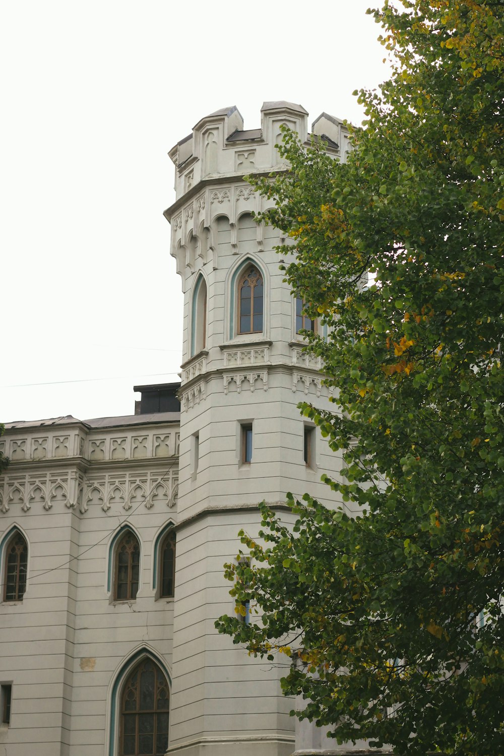 a tall white building with a clock on it's side