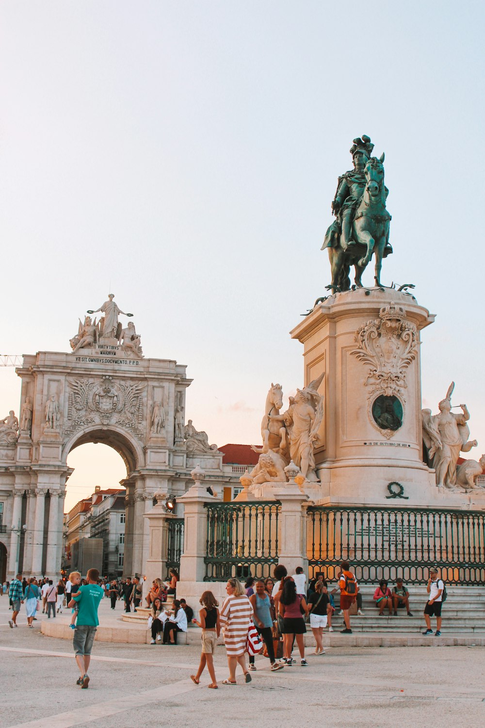 a group of people standing around a statue