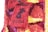 A vibrant floral arrangement featuring numerous small flowers in shades of red, pink, yellow, and purple. The flowers are densely packed to create a textured appearance, with a noticeable pattern resembling a poster or sign, containing blocks of text.