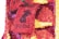A vibrant floral arrangement featuring numerous small flowers in shades of red, pink, yellow, and purple. The flowers are densely packed to create a textured appearance, with a noticeable pattern resembling a poster or sign, containing blocks of text.