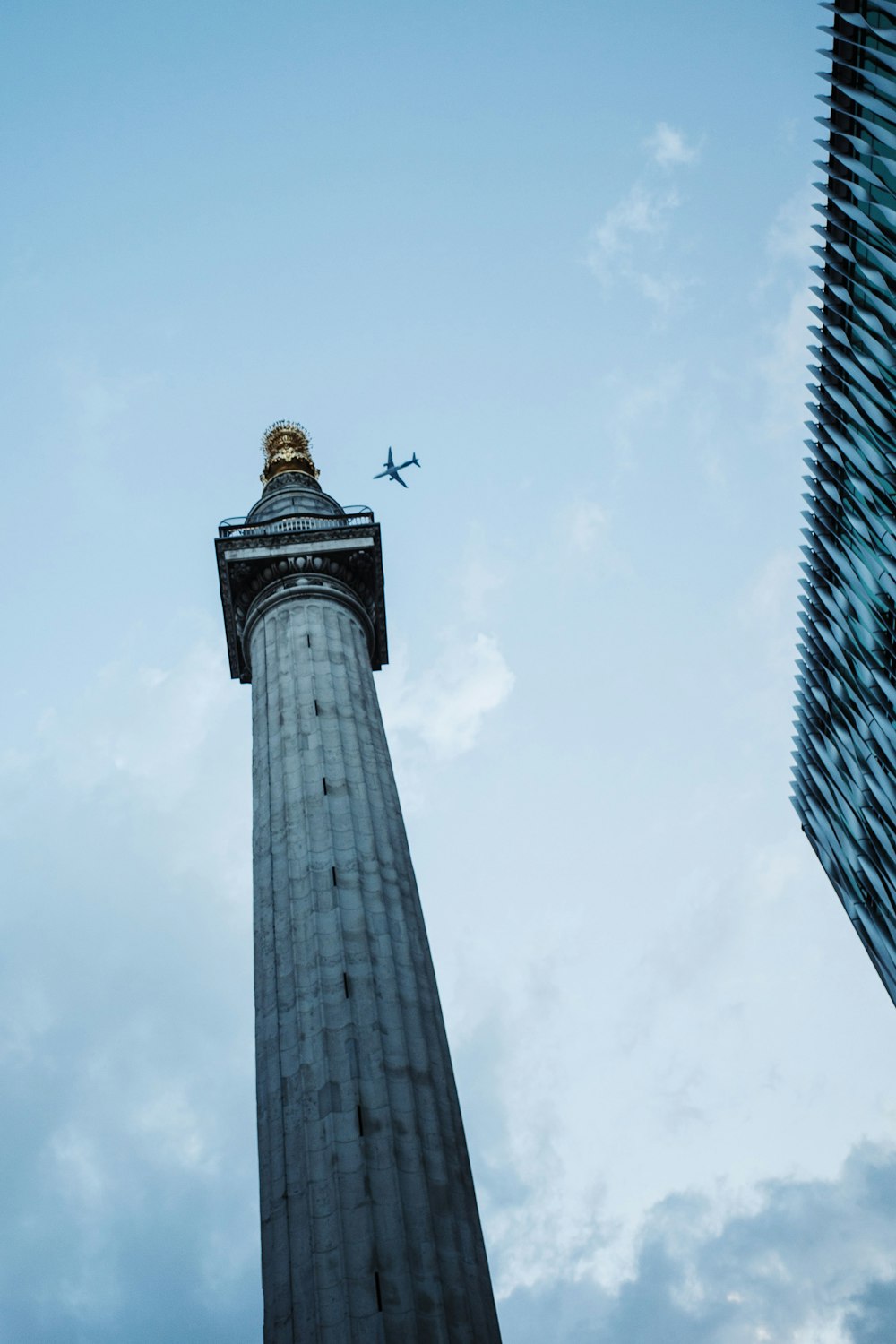 an airplane is flying over a tall building