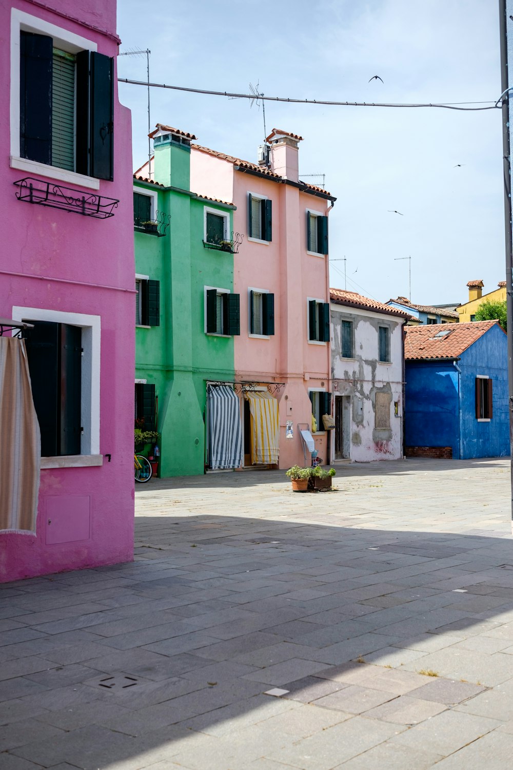 a row of colorful buildings with laundry hanging out to dry