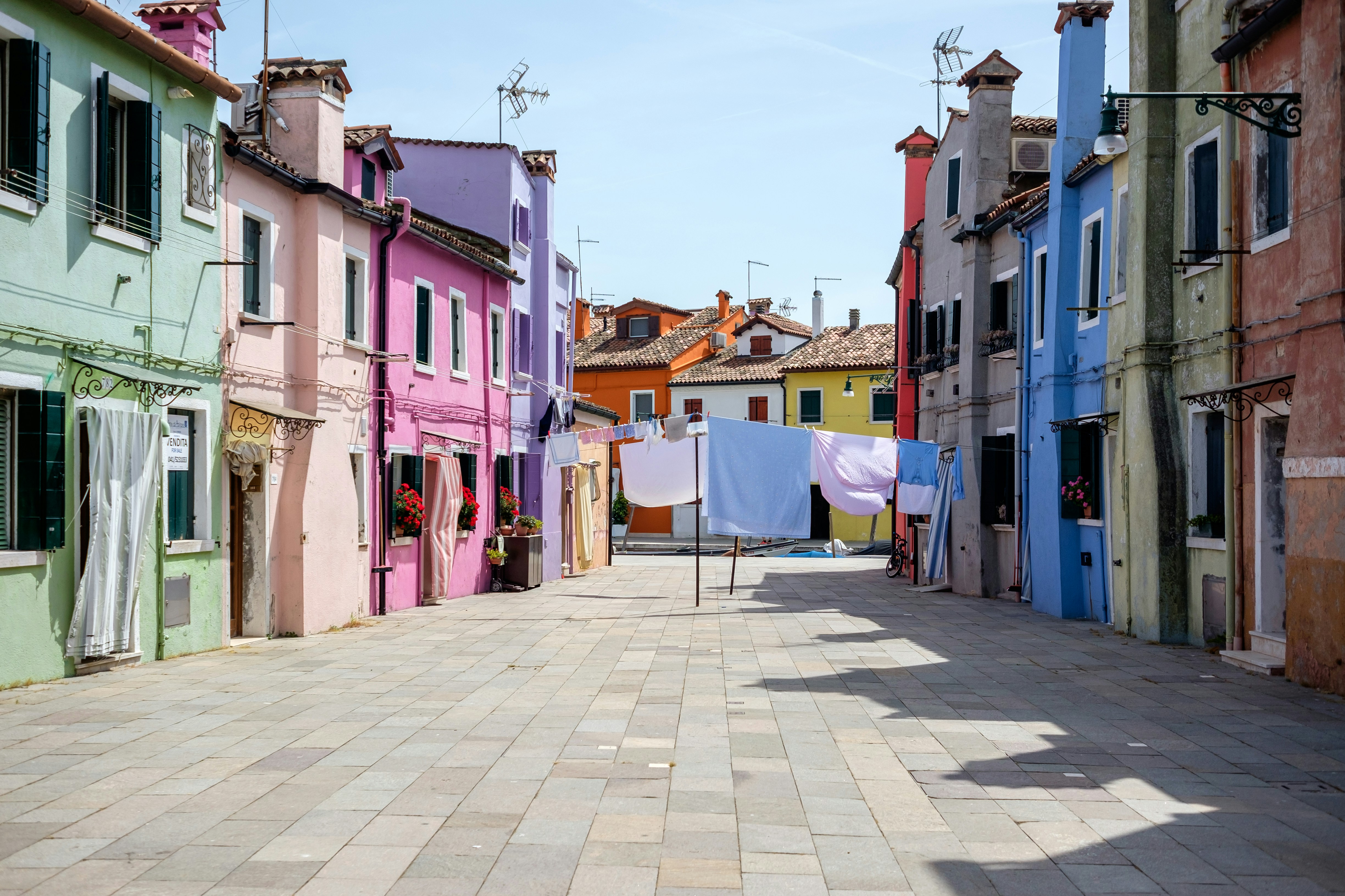 a row of buildings with laundry hanging out to dry