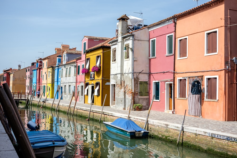 a row of colorful buildings next to a body of water