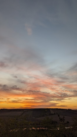 A stunning view of the English countryside with rolling hills and a vibrant sunset.