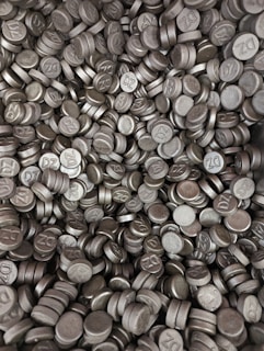 A pile of bright, metallic 99.99% pure zinc ingots ready for shipment.