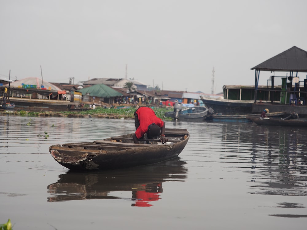 a person in a small boat on a body of water