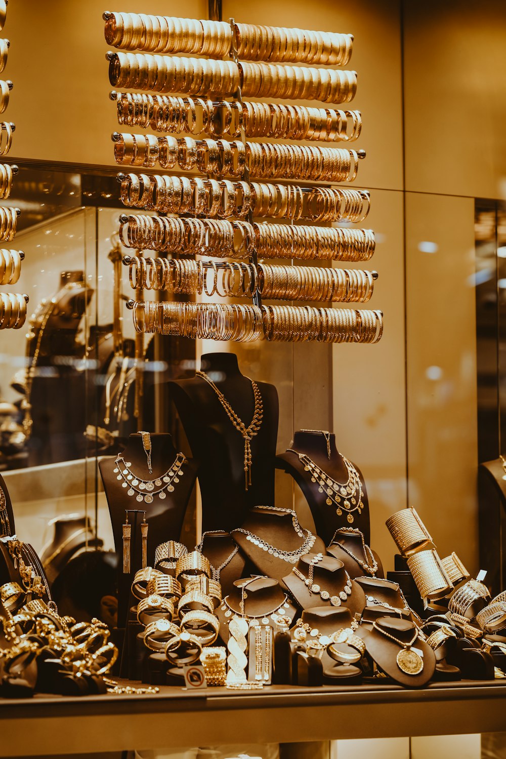 a display in a store filled with lots of gold jewelry