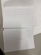 Two cards are placed on a surface, each containing printed text. The top card discusses kindness in a world where we've learned to be kind to children and emphasizes being more generous towards the childlike parts of us. The second card focuses on the value of kindness and its compatibility with success, wealth, and excitement, advocating for its rediscovery and appreciation.