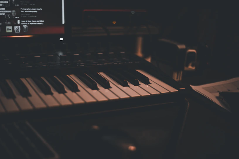 A dimly lit studio with a lone musician immersed in creating intense, emotional music.