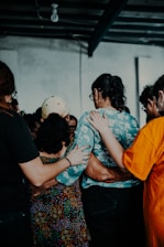 a group of people standing around each other